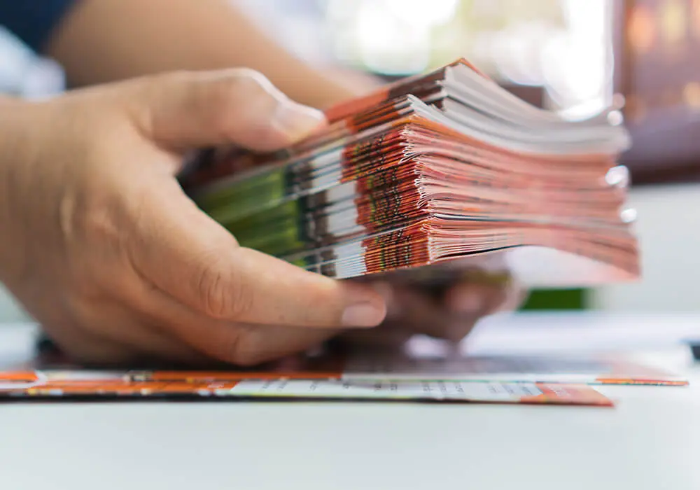 holding-a-stack-of-brochures